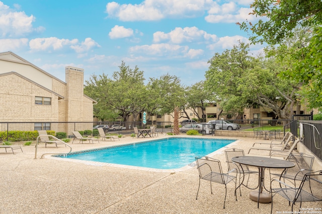 view of swimming pool with a patio