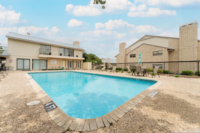 view of swimming pool with a patio area