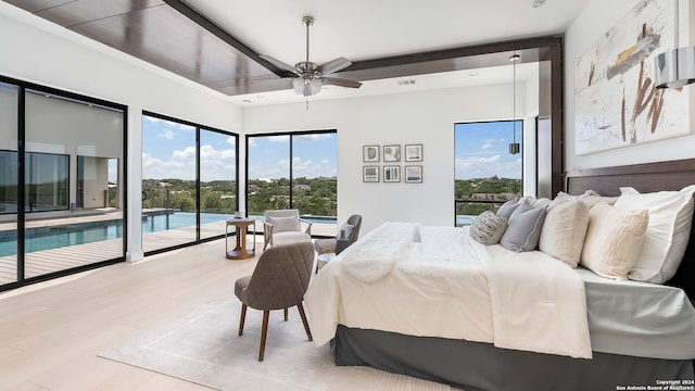 bedroom featuring ceiling fan, access to outside, and wood-type flooring