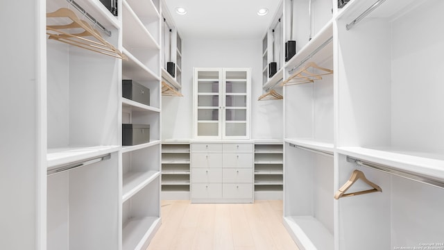 spacious closet featuring light hardwood / wood-style floors