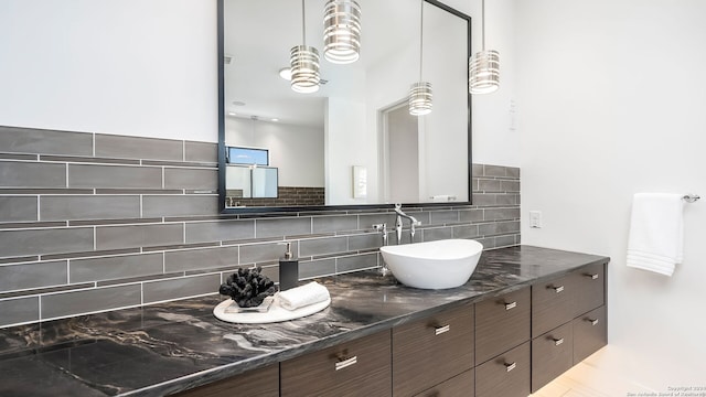 bathroom with tasteful backsplash and vanity