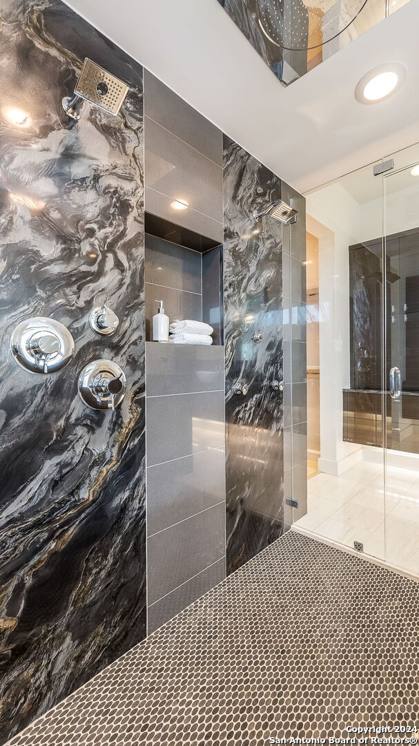 bathroom with a tile shower