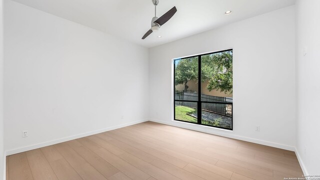 empty room featuring light hardwood / wood-style floors, plenty of natural light, and ceiling fan