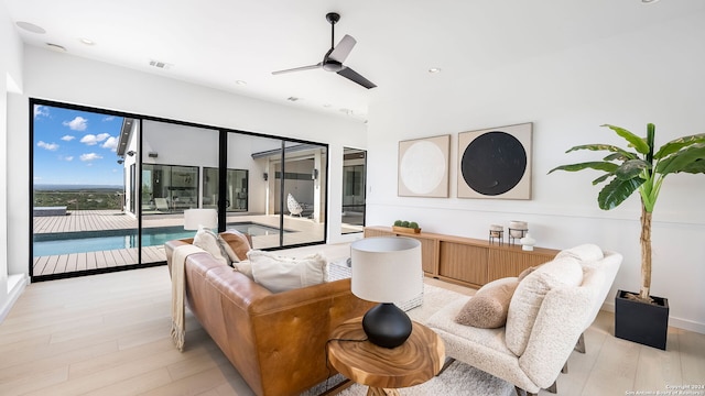 living room featuring ceiling fan and light wood-type flooring