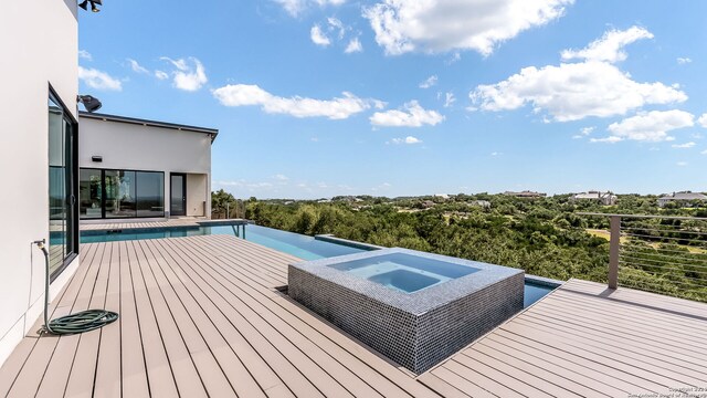 wooden terrace featuring an in ground hot tub