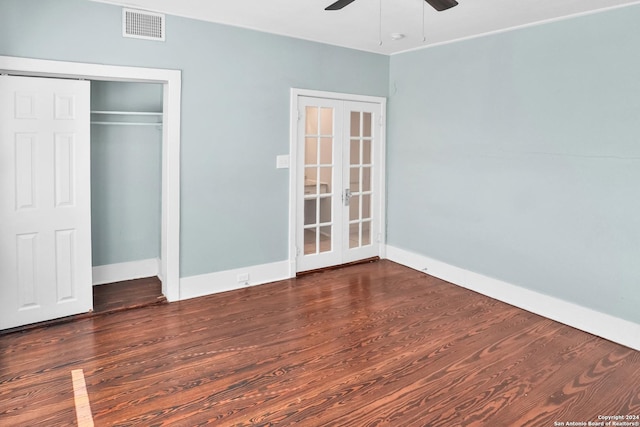 unfurnished bedroom with french doors, dark wood finished floors, visible vents, and baseboards