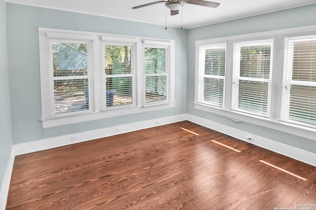 unfurnished sunroom featuring ceiling fan