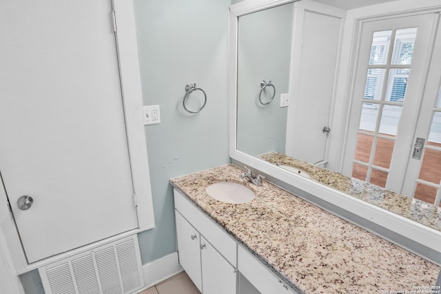 bathroom with visible vents, vanity, and baseboards