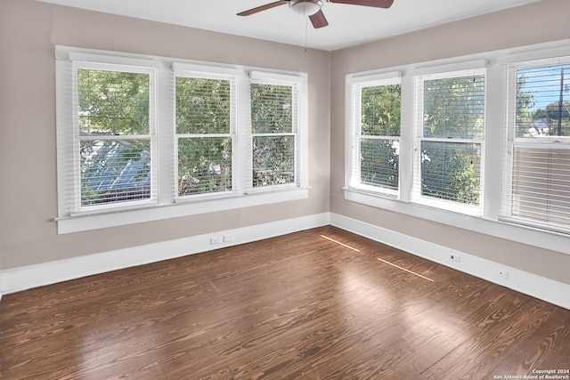 unfurnished sunroom featuring ceiling fan and a wealth of natural light