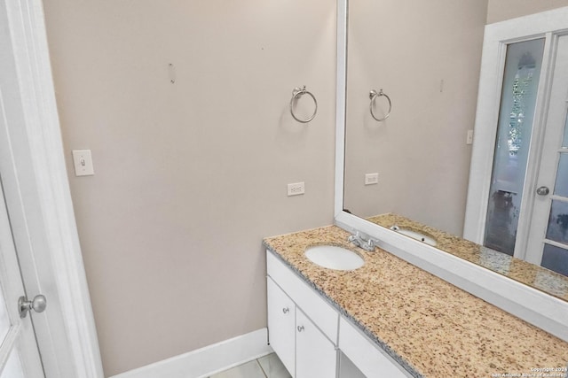 bathroom featuring baseboards and vanity