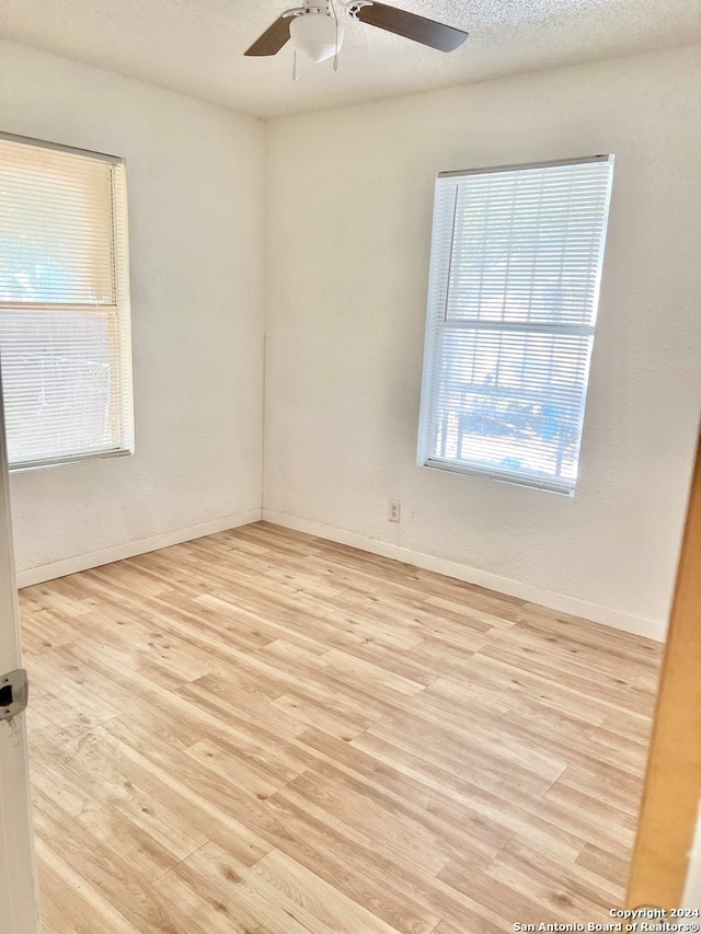 unfurnished room with ceiling fan and light hardwood / wood-style floors