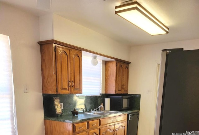 kitchen featuring sink, decorative backsplash, and black appliances