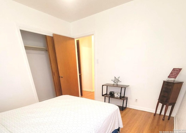 bedroom with a closet and light wood-type flooring