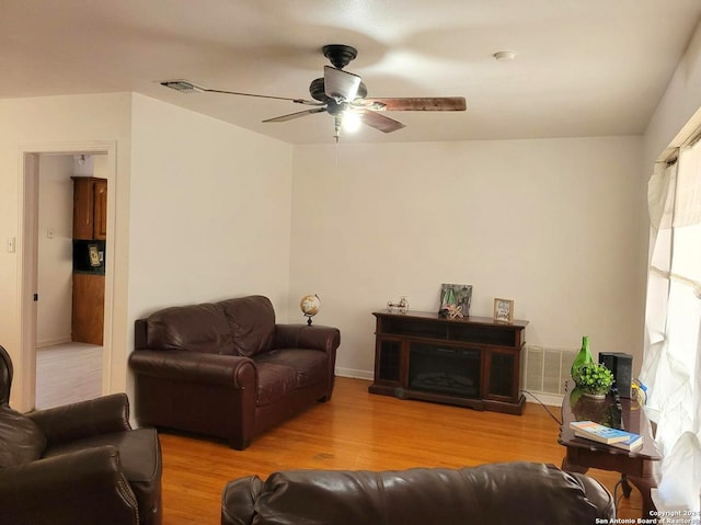 living room with ceiling fan and light wood-type flooring