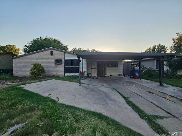 back house at dusk with a carport