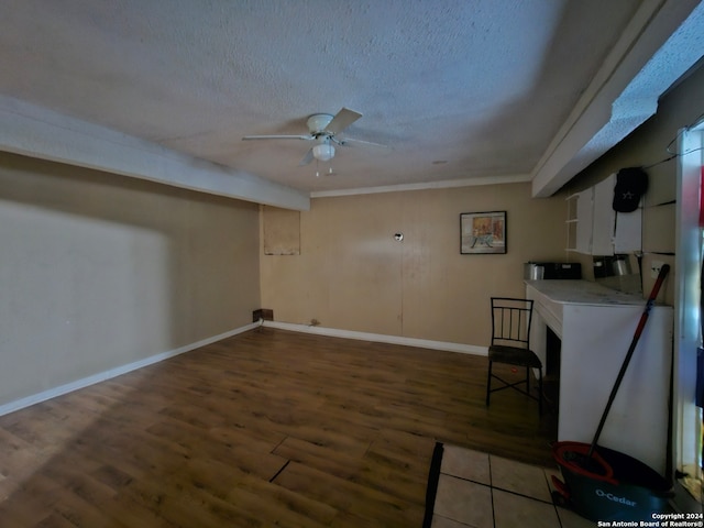 interior space with ceiling fan, hardwood / wood-style flooring, and a textured ceiling