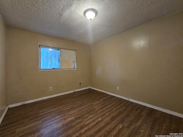 spare room with wood-type flooring and a textured ceiling