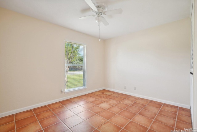 empty room with a ceiling fan and baseboards