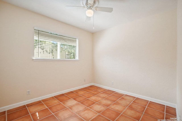 empty room with a ceiling fan and baseboards