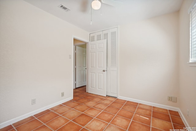 spare room featuring ceiling fan and tile patterned flooring