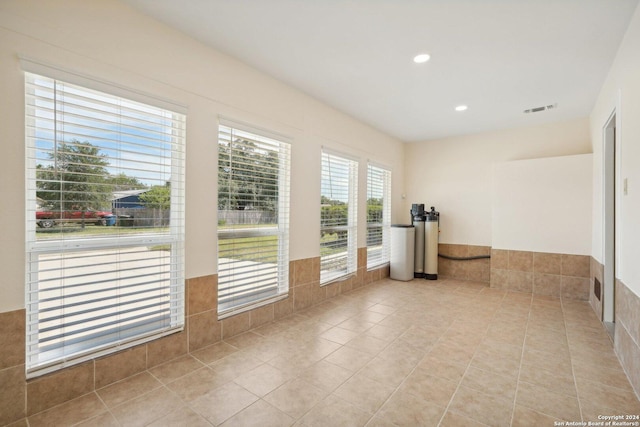 unfurnished room featuring recessed lighting, light tile patterned flooring, and visible vents