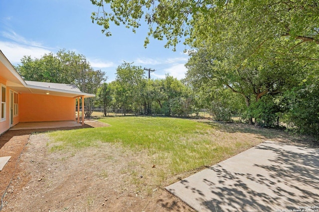 view of yard featuring a patio and fence