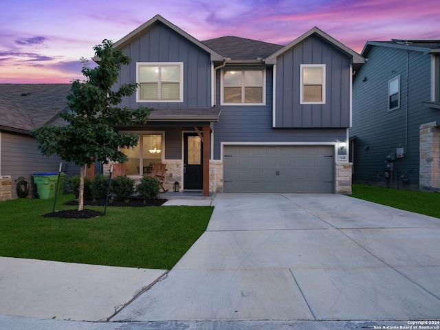 view of front of property with a lawn and a garage