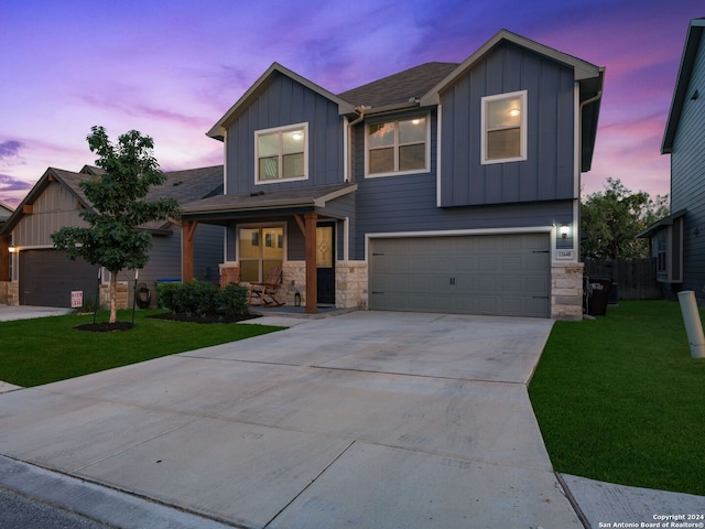 view of front of house with a garage and a lawn