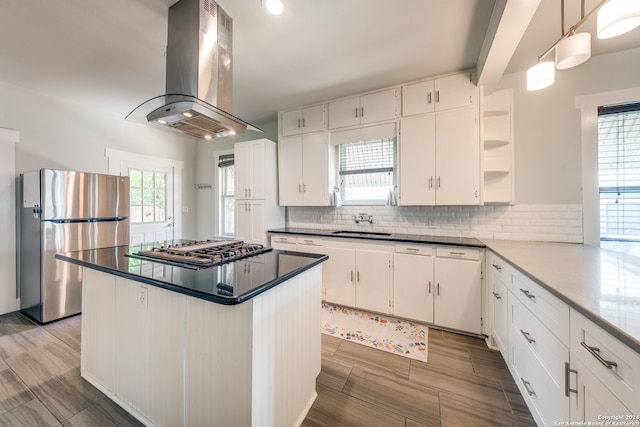 kitchen with white cabinetry, island exhaust hood, backsplash, and stainless steel appliances