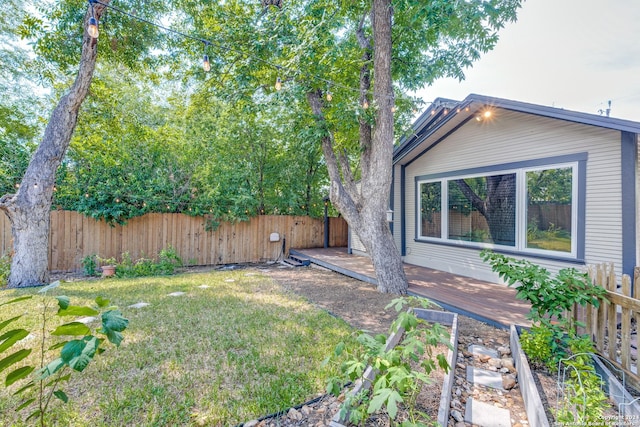 view of yard with a fenced backyard and a wooden deck