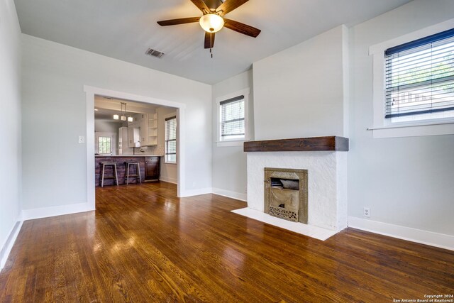 unfurnished living room featuring wood-type flooring and a healthy amount of sunlight