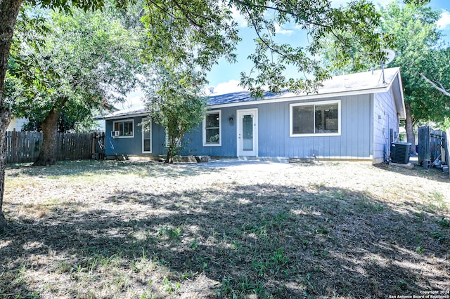 single story home with central AC and a front yard