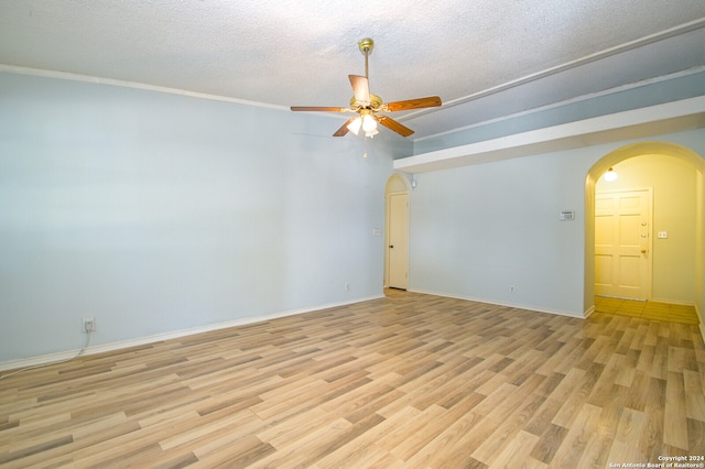 spare room with a textured ceiling, light hardwood / wood-style flooring, ceiling fan, and crown molding