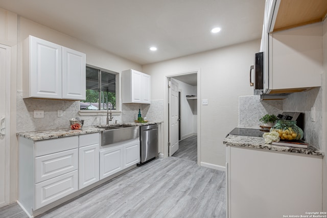 kitchen featuring backsplash, stainless steel appliances, white cabinetry, and sink