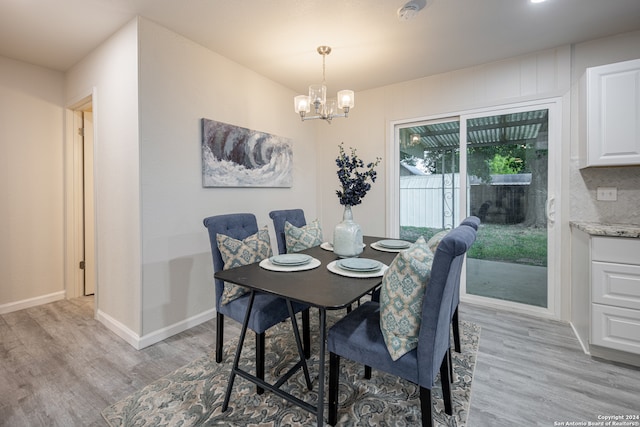 dining space featuring a chandelier and light wood-type flooring