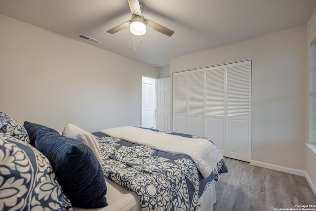 bedroom featuring ceiling fan, a closet, and light hardwood / wood-style floors