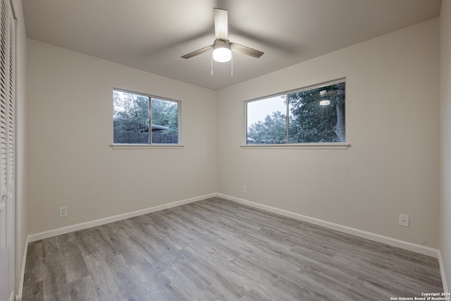 spare room featuring ceiling fan and light wood-type flooring