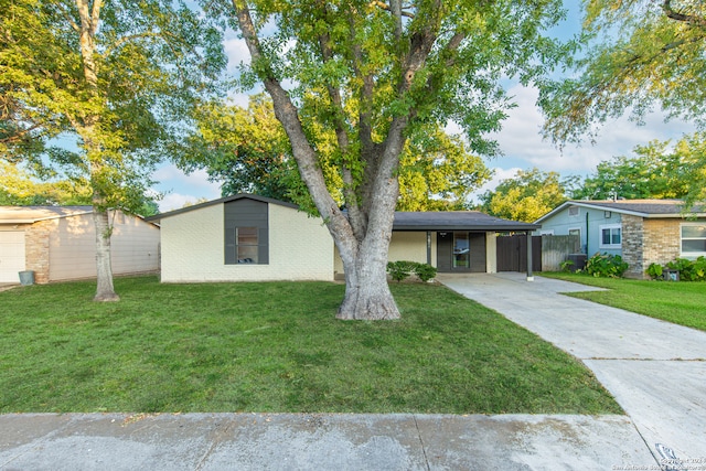 ranch-style home with a front lawn and a carport