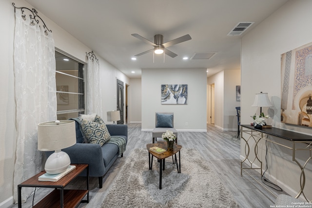 living room with ceiling fan and wood-type flooring