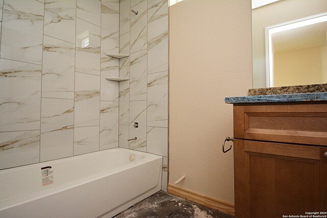 bathroom featuring marble finish floor, shower / bathing tub combination, vanity, and baseboards