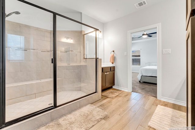 bathroom with ceiling fan, hardwood / wood-style floors, vanity, and walk in shower