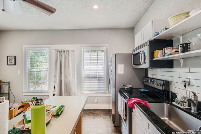 kitchen featuring dark hardwood / wood-style flooring, appliances with stainless steel finishes, a healthy amount of sunlight, and ceiling fan