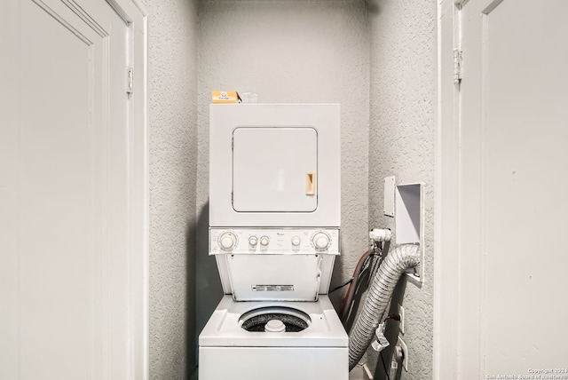 washroom featuring stacked washer / dryer