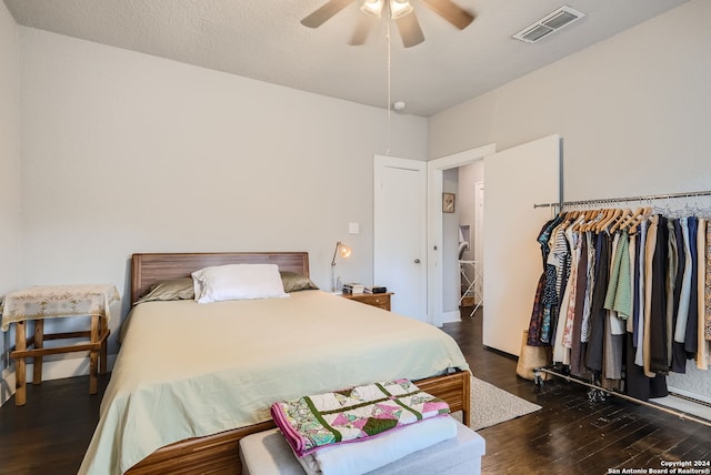 bedroom with ceiling fan and dark wood-type flooring