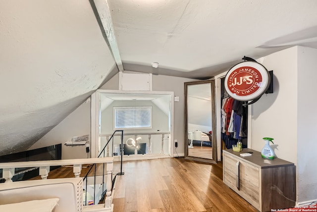 bonus room featuring light hardwood / wood-style floors and lofted ceiling