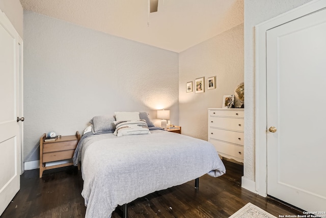 bedroom with ceiling fan and dark wood-type flooring