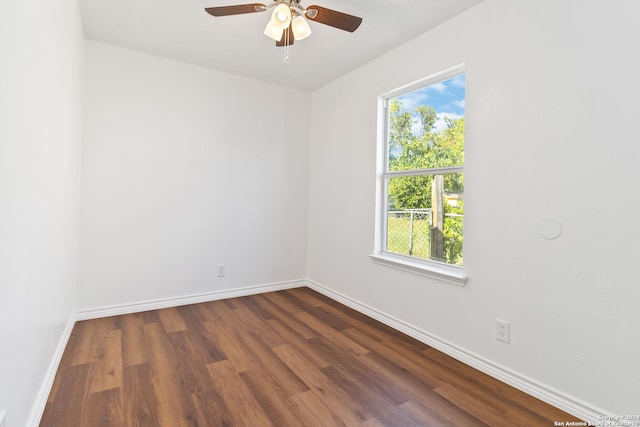 spare room featuring dark hardwood / wood-style flooring, a healthy amount of sunlight, and ceiling fan