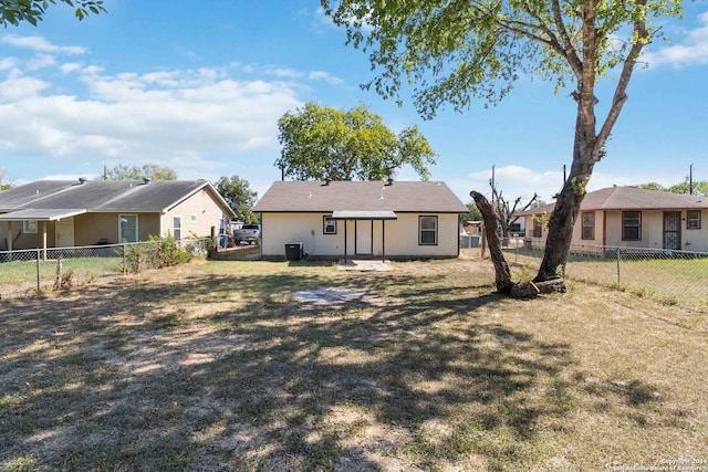 rear view of house featuring a lawn