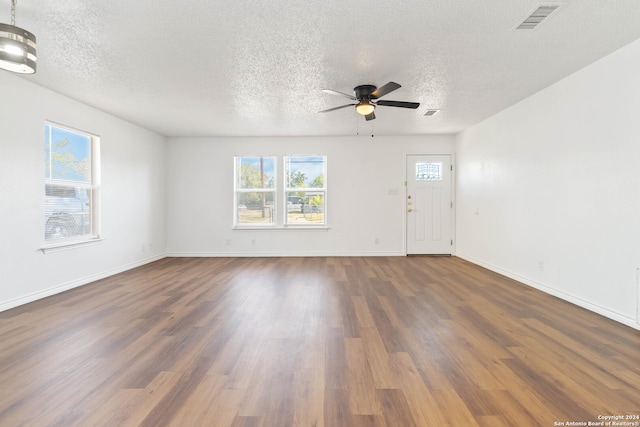 unfurnished room featuring a textured ceiling, ceiling fan, and hardwood / wood-style floors