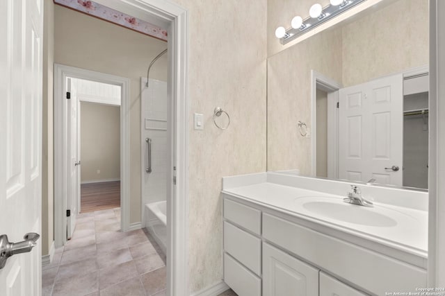 bathroom with tile patterned flooring, vanity, and bathtub / shower combination